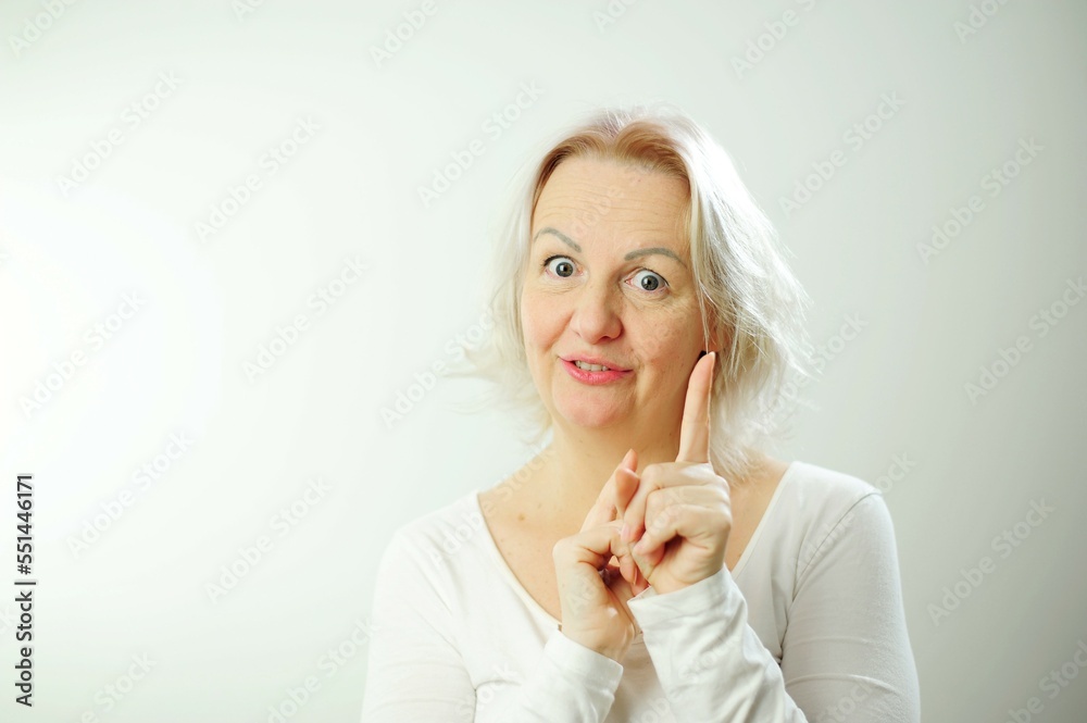 Close up portrait of gorgeous, nice, stunning, adorable good serious stylish girl raises finger up says Attention please Young stylish female teacher tries to explain something to pupils Close up portrait of gorgeous, nice, stunning, adorable good serious stylish girl raises finger up says Attention please Young stylish female teacher tries to explain something to pupils