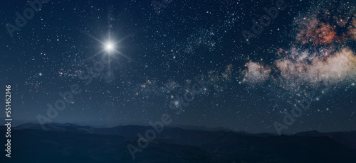 The star shines over the manger of christmas of Jesus Christ. © vovan