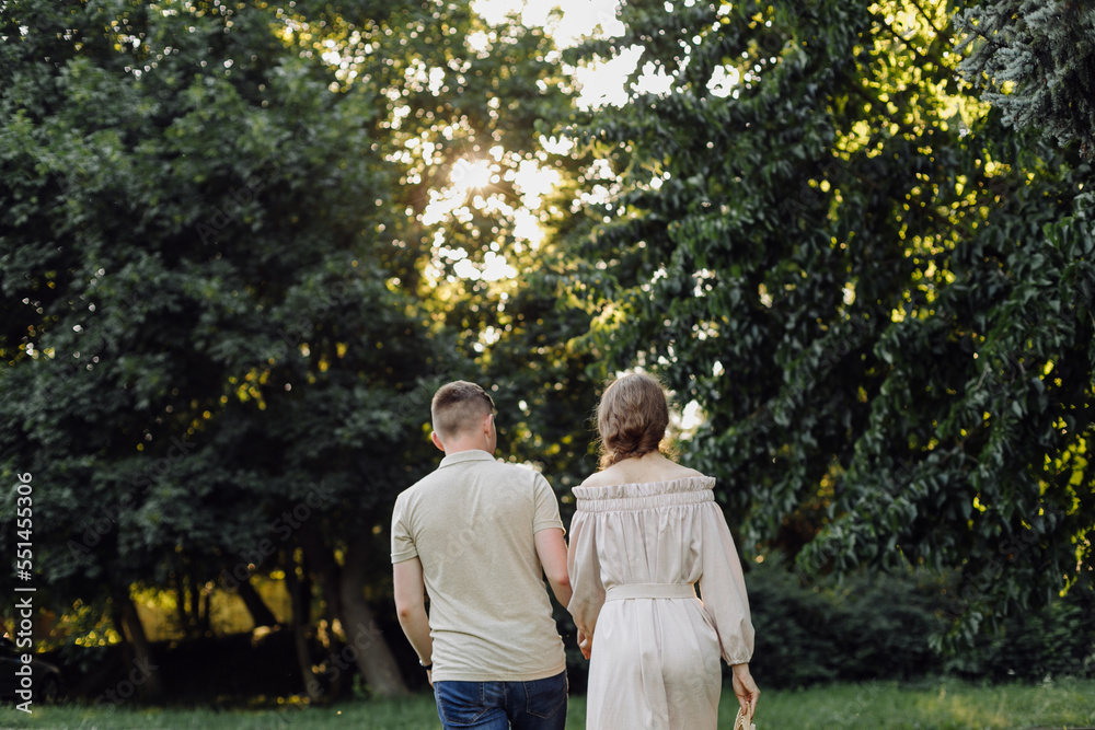Young couple in love outdoor.Stunning sensual outdoor portrait of young stylish fashion couple posing in summer in field Young couple in love outdoor.Stunning sensual outdoor portrait of young stylish fashion couple posing in summer in field
