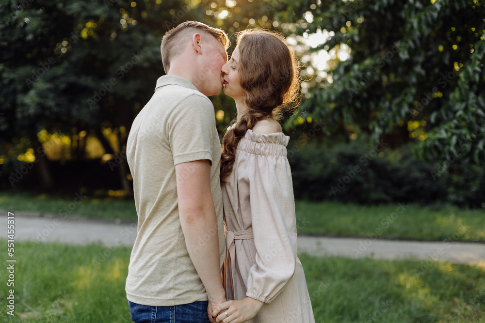Fototapeta premium Young couple in love outdoor.Stunning sensual outdoor portrait of young stylish fashion couple posing in summer in field