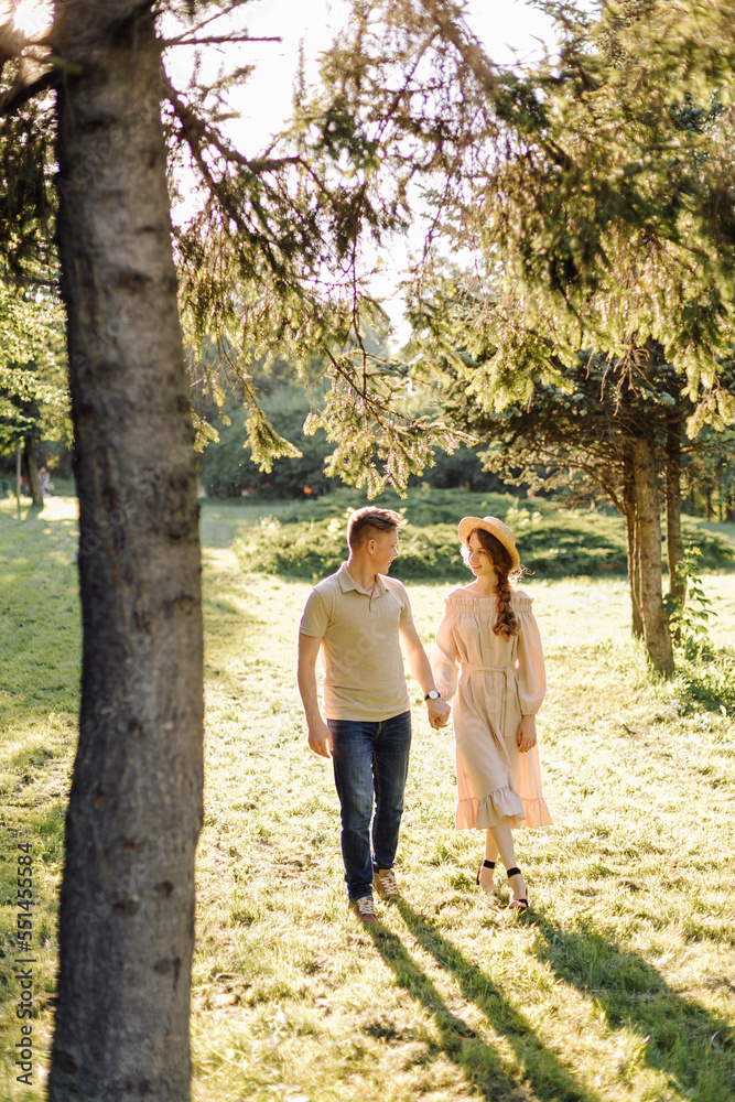 Young couple in love outdoor.Stunning sensual outdoor portrait of young stylish fashion couple posing in summer in field Young couple in love outdoor.Stunning sensual outdoor portrait of young stylish fashion couple posing in summer in field