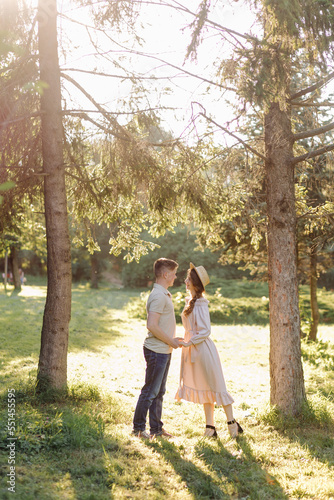 Young couple in love outdoor.Stunning sensual outdoor portrait of young stylish fashion couple posing in summer in field