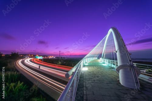 Beautiful and romantic colorful car light track. Night view of white bridge. Long exposure photography captures light trail images. Harp Bridge, Xiangshan District, Hsinchu County. photo