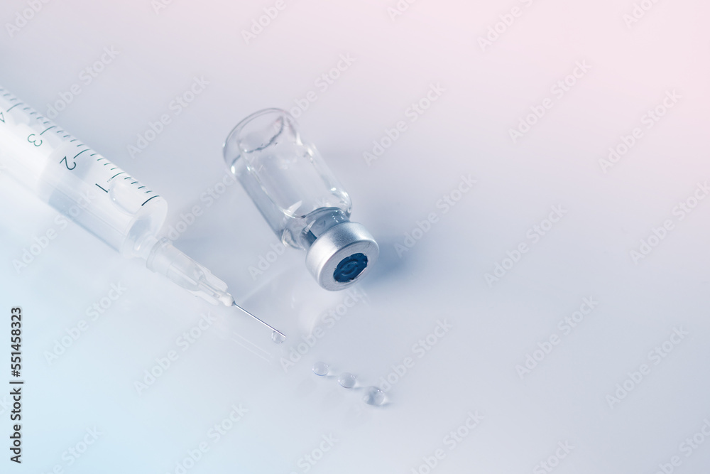 Glass vial and syringe with injection. Vaccination or beauty therapy concept. Glass vial and syringe with injection. Vaccination or beauty therapy concept.