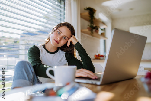 Portrait of bored woman with laptop, homeoffice concept. photo