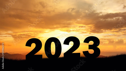 New Year 2023 over the cliff at amazing sunset. of black silhouettes New year's concept of starting and welcoming the new year 2023.