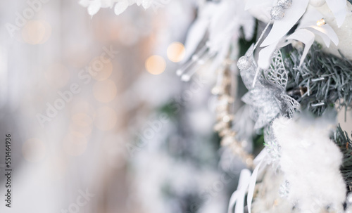 Beautiful white Christmas background with silver branches and decorations. Selective focus, space for text
