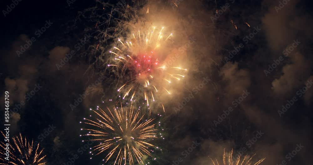 New year's eve fireworks display celebration loop seamless of real fireworks background with abstract multicolor big shining glowing fireworks show with bokeh lights in the night sky. 4KDCI