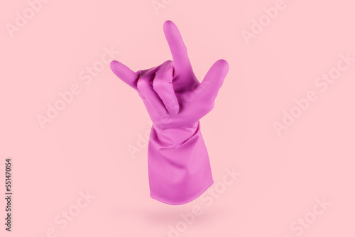 Pink cleaning glove doing the metal rock geture with his fingers on a pink background