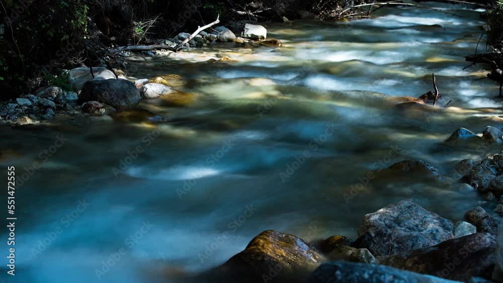 Closeup of Gurgling Water over Cobblestone in a River Closeup of Gurgling Water over Cobblestone in a River