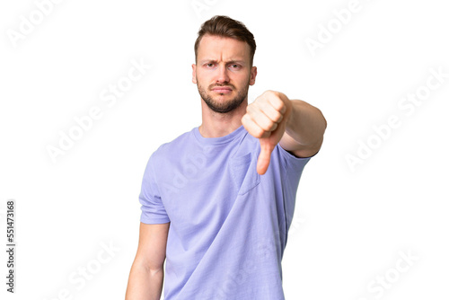 Young handsome caucasian man over isolated chroma key background showing thumb down with negative expression