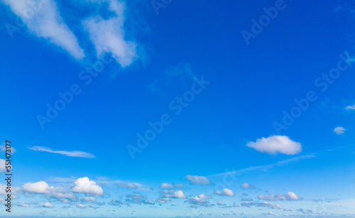 Beautiful view of blue sky with clouds. Beautiful shapes, partly cloudy. Colorful sunset. Natural sky background texture, beautiful color. Bright landscape in the blue sky.