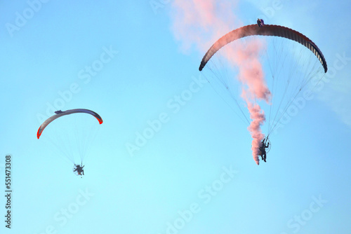 Paraglider flying against the blue sky with clouds, outdoor activities, extreme sports, extreme sport, paraglider flying in the sun