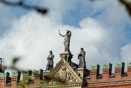 Low-angle closeup of roof statues of Saint Canute's brick-built gothic cathedral photo