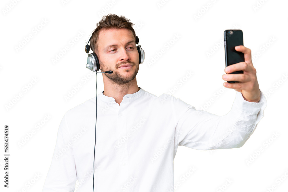 Telemarketer caucasian man working with a headset over isolated chroma key background making a selfie Telemarketer caucasian man working with a headset over isolated chroma key background making a selfie