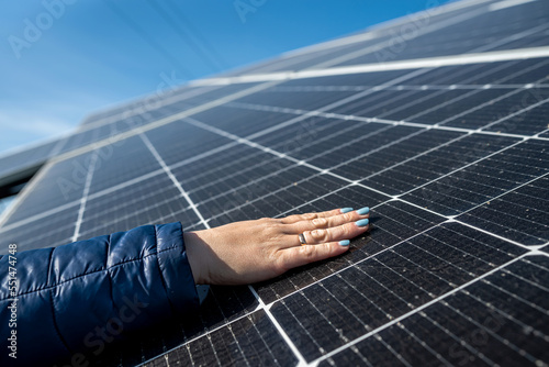 hand of female engineer checking solar operation cleanliness of photovoltaic solar panels sun.