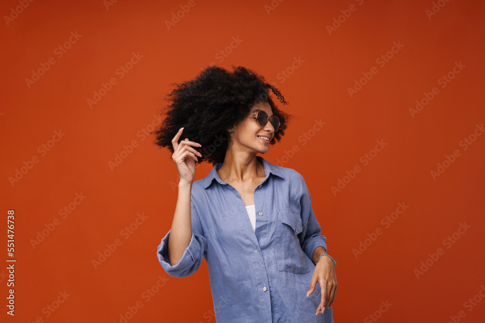 Young beautiful stylish curly smiling woman in sun glasses dancing Young beautiful stylish curly smiling woman in sun glasses dancing