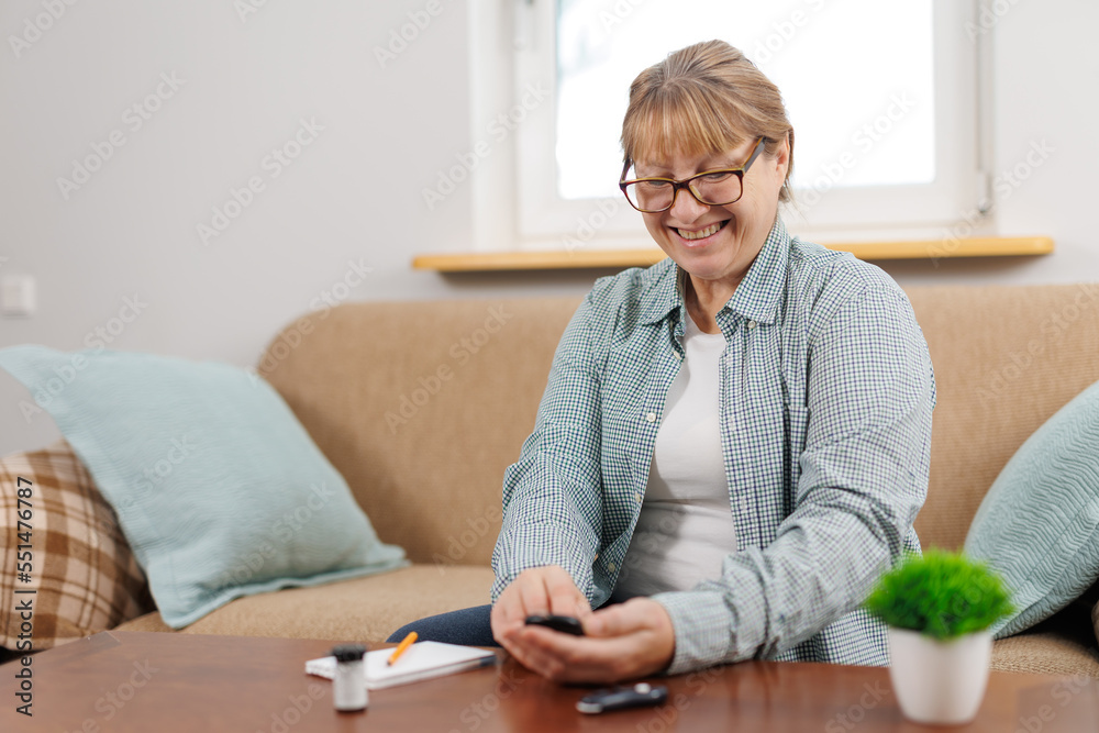 Woman measures blood sugar glucose meter, diabetes concept, notebook for writing and monitoring. Woman write blood glucose level from glucose meter, medical consultation and examination in hospital. Woman measures blood sugar glucose meter, diabetes concept, notebook for writing and monitoring. Woman write blood glucose level from glucose meter, medical consultation and examination in hospital.