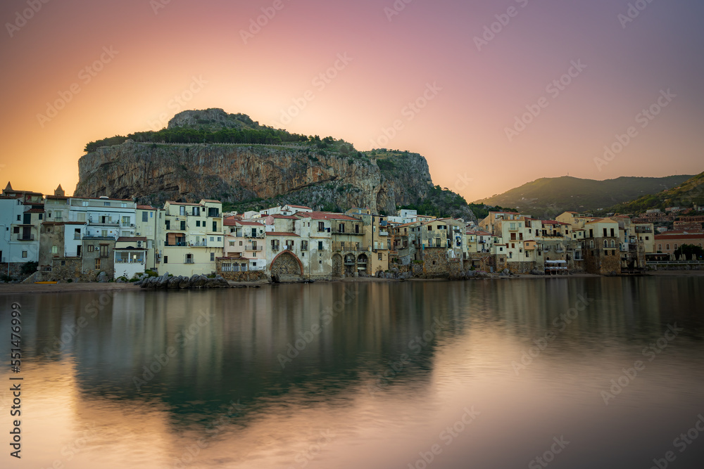 Sunrise behind the mountain. View of the old town of Cefalu, Mediterranean coast, Sicily, Italy.
