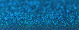 Blurred navy blue sparkling background from small sequins for new year or christmas, macro.