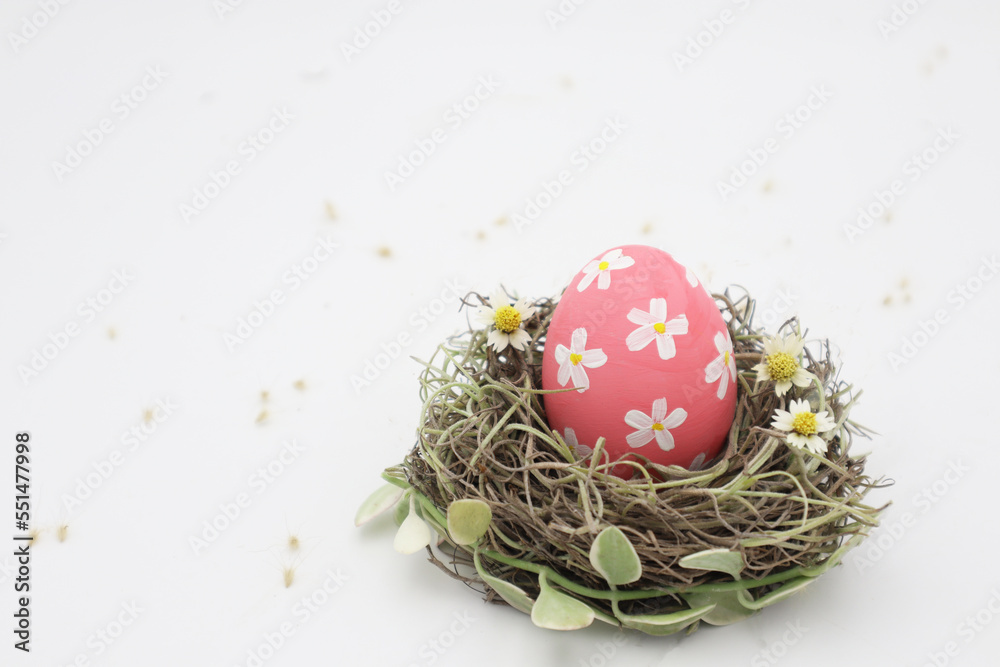 Obraz premium Pink pastel easter egg in nest 