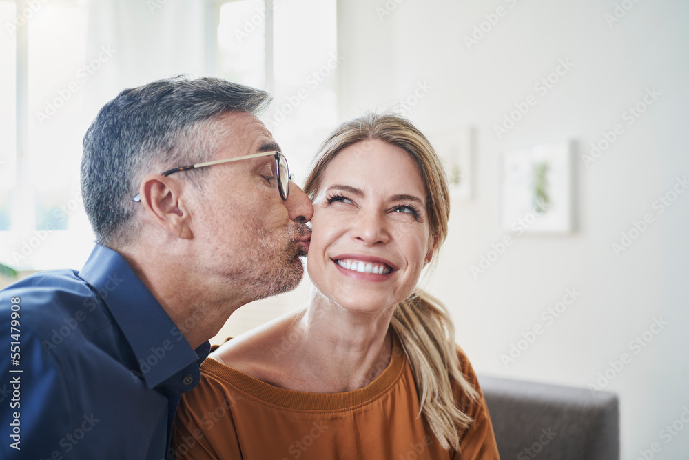 Mature man kissing woman at home Mature man kissing woman at home