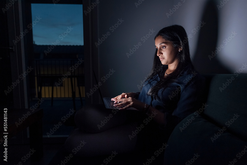 Woman using laptop in room at home Woman using laptop in room at home