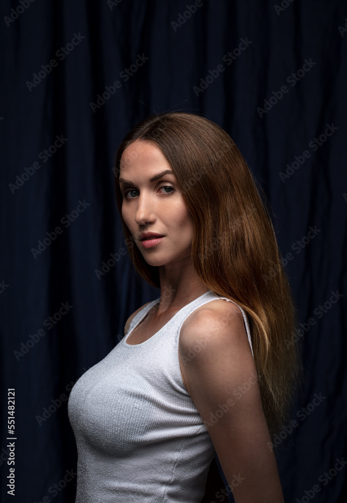 portrait of a young attractive woman on a dark background