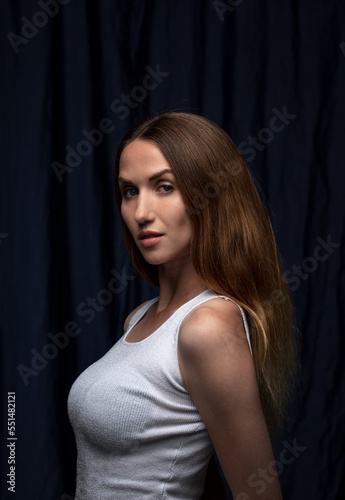 portrait of a young attractive woman on a dark background