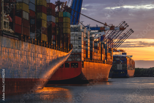 Germany, Hamburg, Container ships in Port of Hamburg at dusk photo