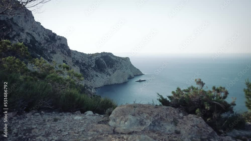 Looking over the edge of a cliff on the west coast of Ibiza Looking over the edge of a cliff on the west coast of Ibiza