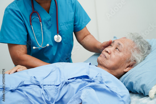 Asia doctor with stethoscope checking elderly woman patient in hospital, healthy medical concept.