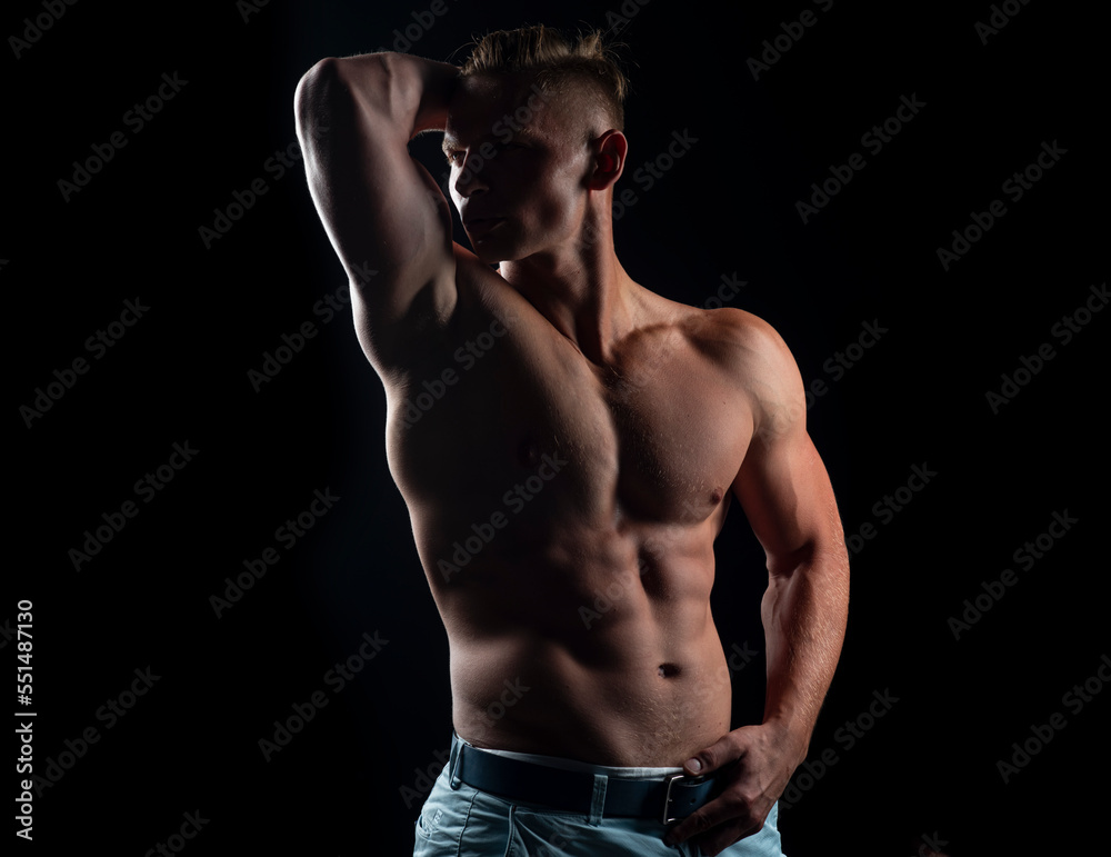 Fototapeta premium Mans powerful shoulders. Chest muscles. Muscular shirtless manked man model showing strong shoulders, bare chest. Gay sexy model.