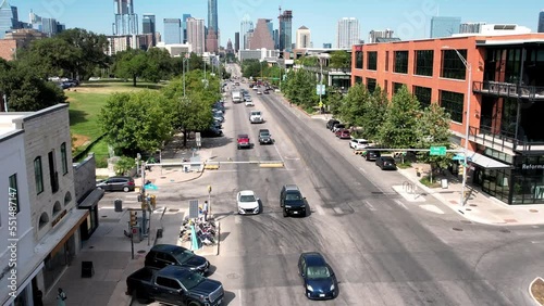 Aerial drone shot flying over two way road with cars passing by beside Austin Motel at daytime. photo