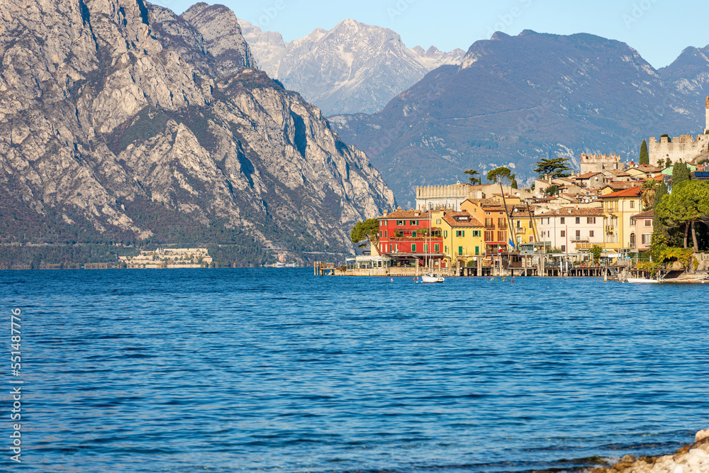 Malcesine village. Famous tourist resort on the coast of Lake Garda (Lago di Garda), Verona province, Italy, Veneto, southern Europe. On background the coast of Lombardy.