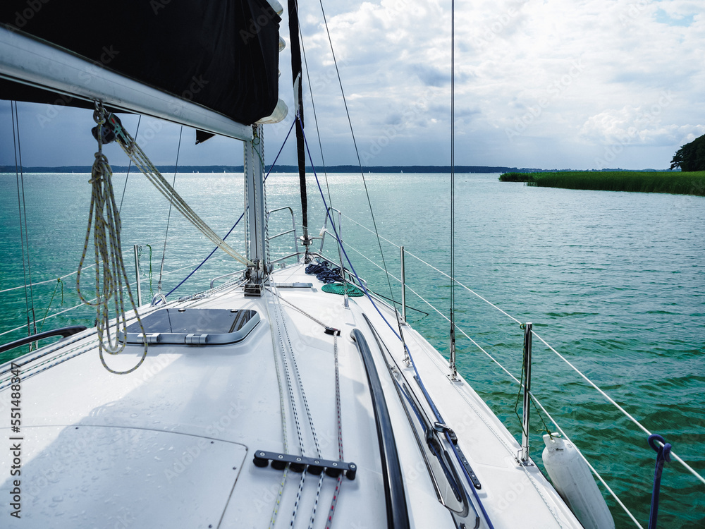 view on sailing yacht bow sailing on a lake before rain