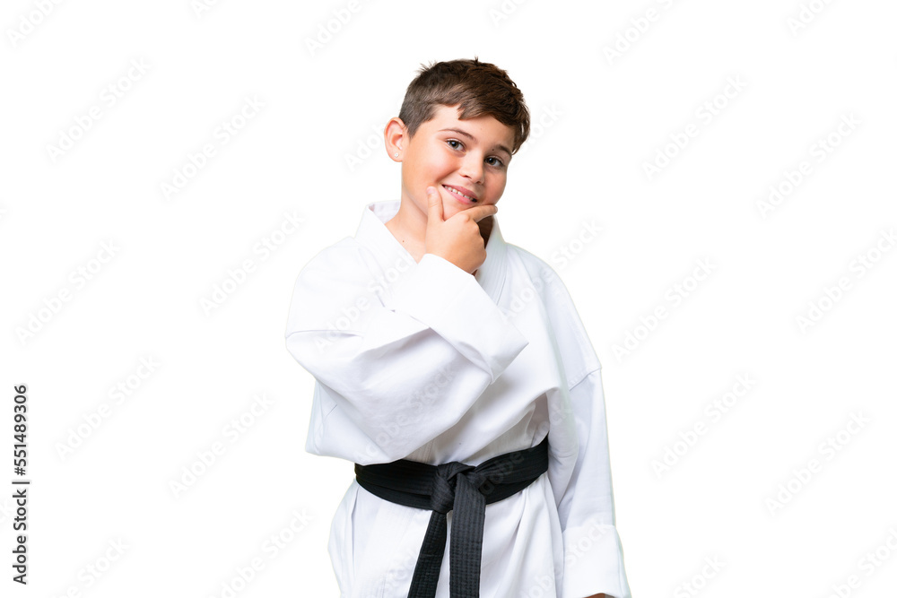 Little caucasian kid doing karate over isolated chroma key background happy and smiling Little caucasian kid doing karate over isolated chroma key background happy and smiling