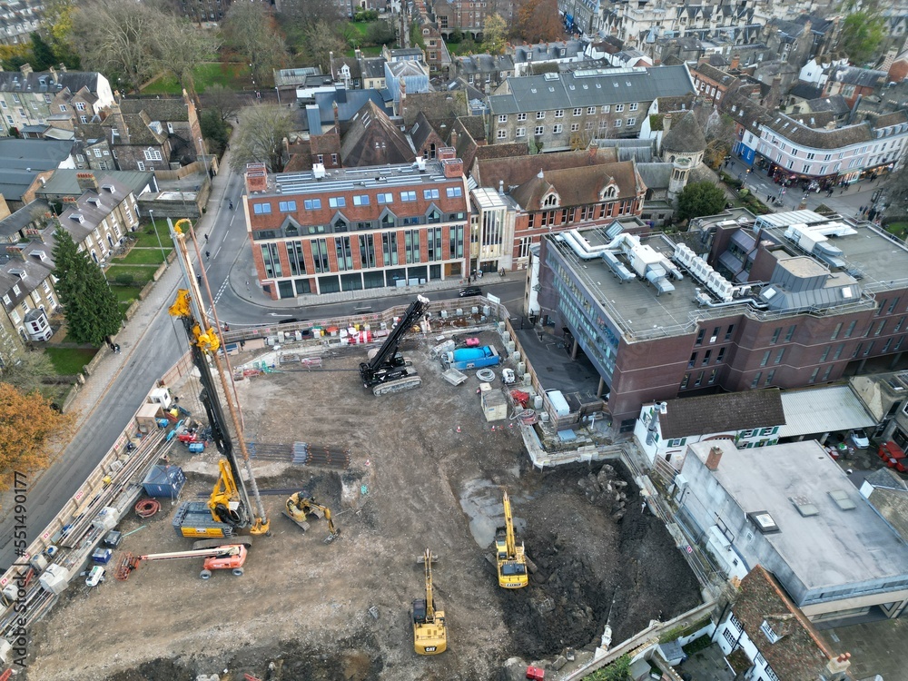 Screw pile driving machine on building site Cambridge City centre UK drone aerial..