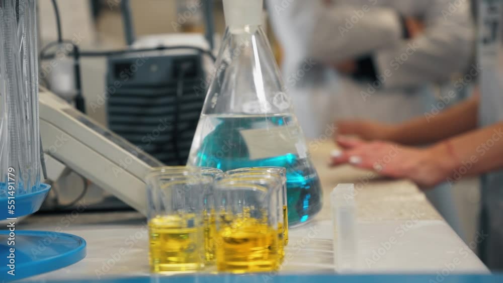 Yellow and blue flasks in the doctor's room. Glass equipment in a laboratory for scientific or chemical experiments