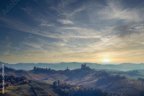 landscapes of the Piedmontese Langhe with the famous medieval castle of Serralunga d'Alba, with the bright colors of the autumn season