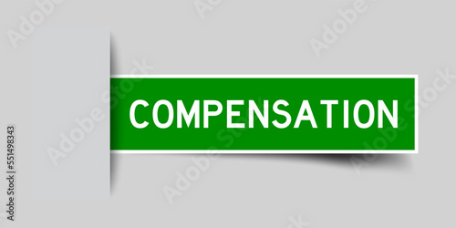 Inserted green color label sticker with word compensation on gray background