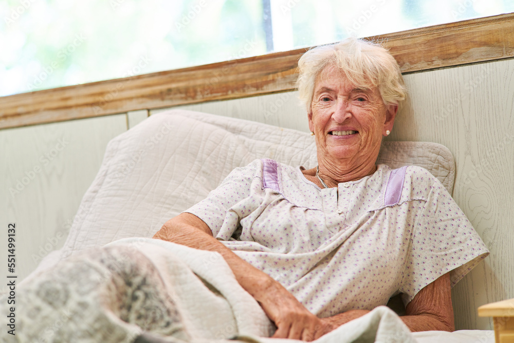 Smiling senior woman as a bedridden patient in bed Smiling senior woman as a bedridden patient in bed