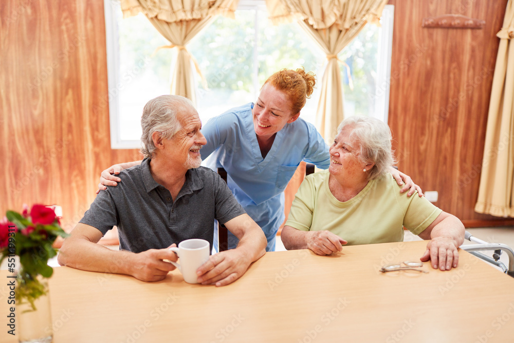 Smiling caregiver talking to senior couple Smiling caregiver talking to senior couple