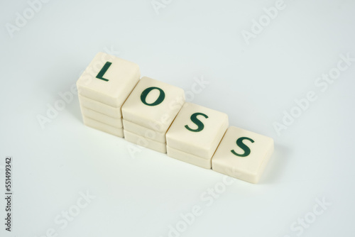 Loss and economic downfall concept, losing money, loss text on white blocks, rising prices and tax idea, crisis and collapse, bad economy, decreasing money value