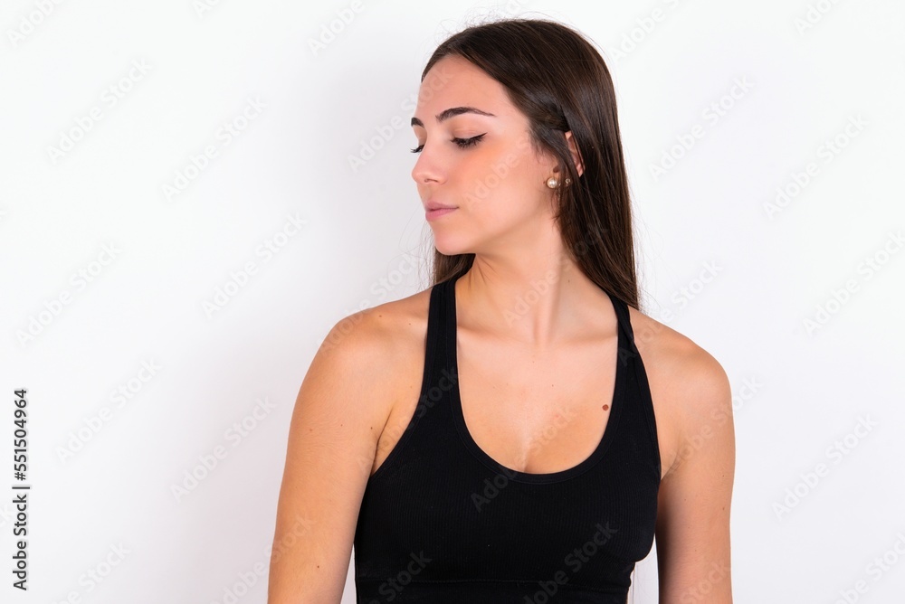 Side view of young happy smiling Young caucasian woman wearing sportswear over white background Side view of young happy smiling Young caucasian woman wearing sportswear over white background