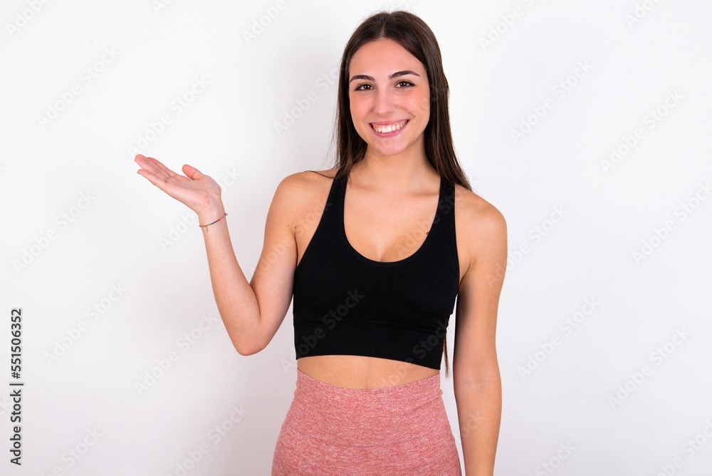 Positive glad MODEL says: wow how exciting it is, has amazed expression, shows something on blank space with open hand. Advertisement concept. Positive glad MODEL says: wow how exciting it is, has amazed expression, shows something on blank space with open hand. Advertisement concept.
