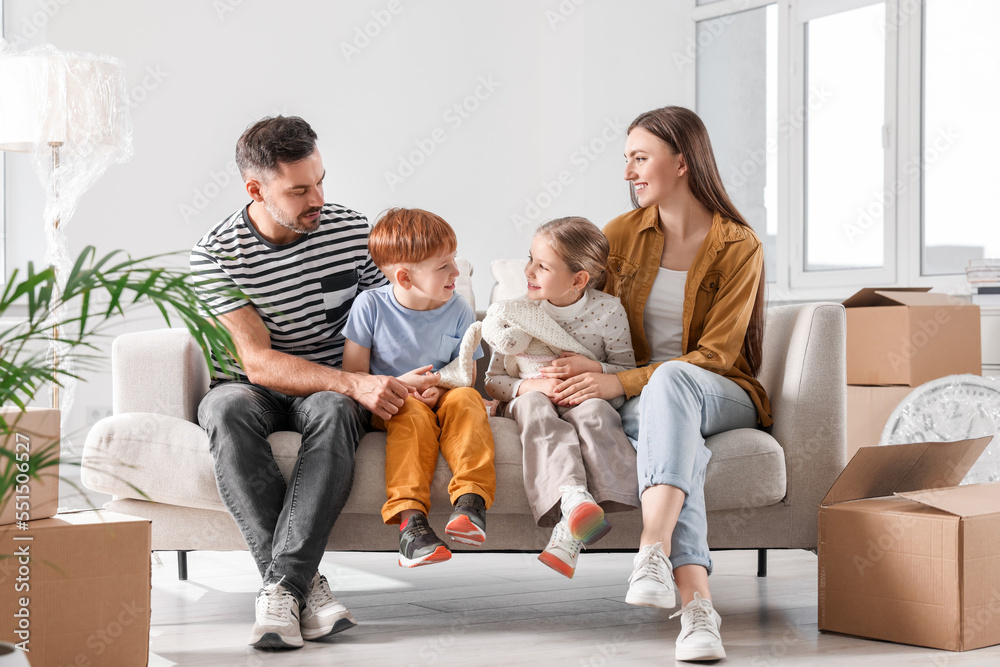 Happy family sitting on couch in new apartment. Moving day Happy family sitting on couch in new apartment. Moving day