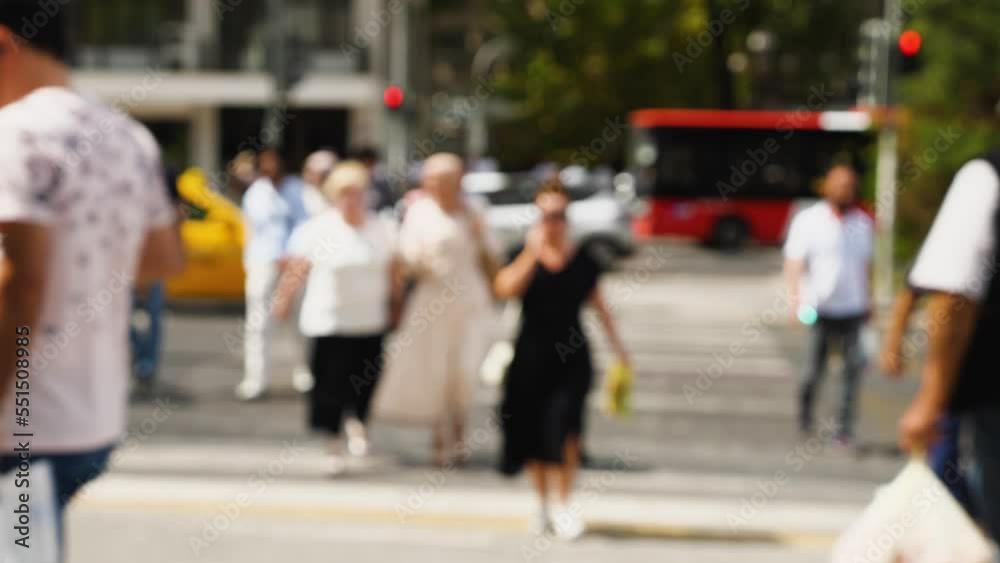 People cross the street at a crosswalk. Blurred video. Observance of traffic rules in the city. A crowd of people at a crosswalk People cross the street at a crosswalk. Blurred video. Observance of traffic rules in the city. A crowd of people at a crosswalk