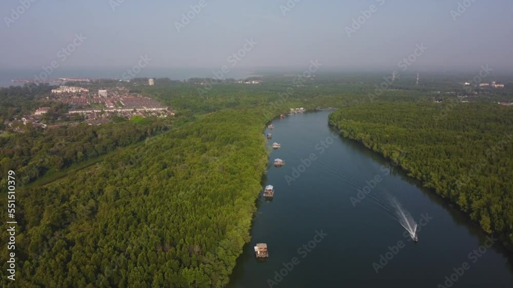Aerial View of floating house and boat cruising on Bagan Lalang river, Sepang Aerial View of floating house and boat cruising on Bagan Lalang river, Sepang