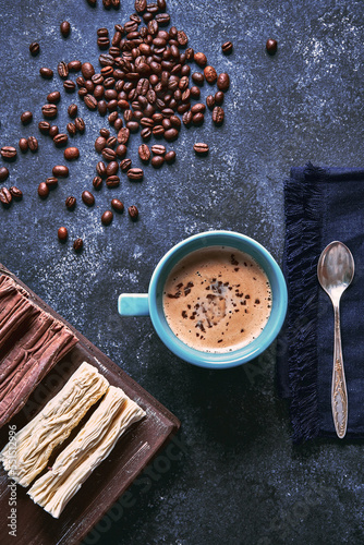 cup of coffee with roasted coffee beans and chocolate background